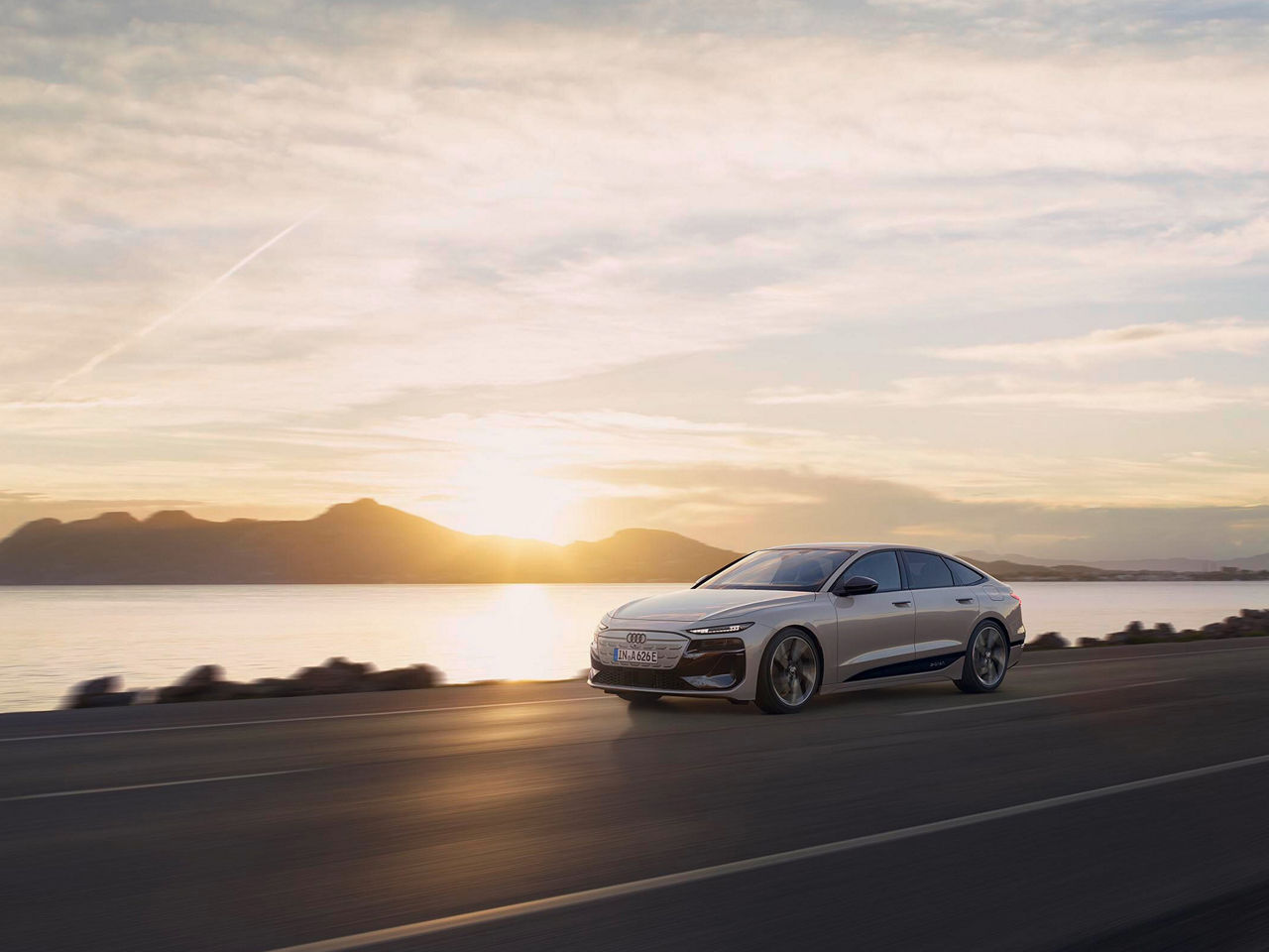 Audi A6 Sportback e-tron performance drives in front of a sunset